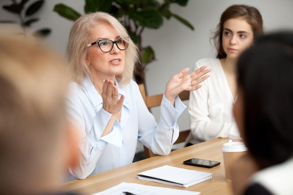A woman talking during a work meeting.